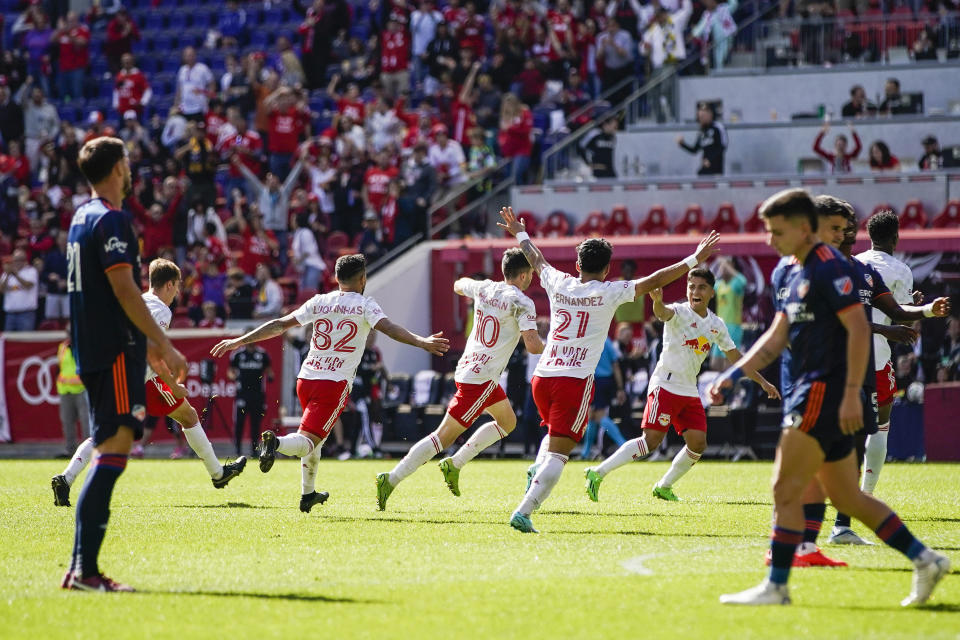 New York Red Bulls midfielder Lewis Morgan (10), center, celebrates with teammates after scoring a goal against the FC Cincinnati during the second half of an MLS soccer playoff match, Saturday, Oct. 15, 2022, in Harrison, N.J. (AP Photo/Eduardo Munoz Alvarez)