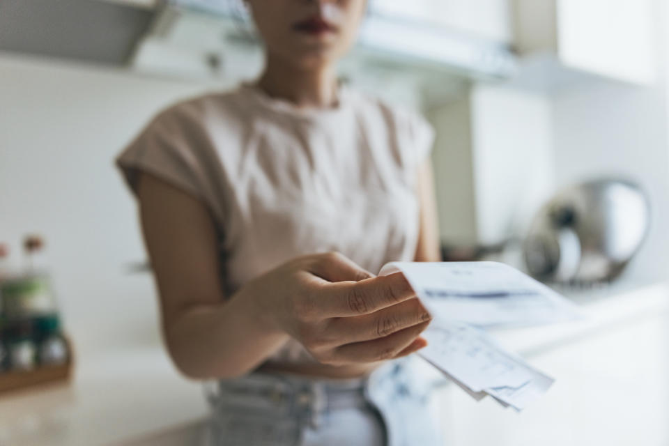 a person holding paper bills