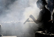 A woman grills bratwurst at a Christmas market during unseasonably warm weather in downtown Denver on Friday, Dec. 3, 2021. The Mile High City has already shattered its 87-year-old record for the latest measurable snowfall set on Nov. 21, 1934, and it's a little more than a week away from breaking an 1887 record of 235 consecutive days without snow. The scenario is playing out across much of the Rocky Mountains, as far north as Montana and in the broader Western United States, which is experiencing a megadrought that studies link to human-caused climate change. (AP Photo/Thomas Peipert)