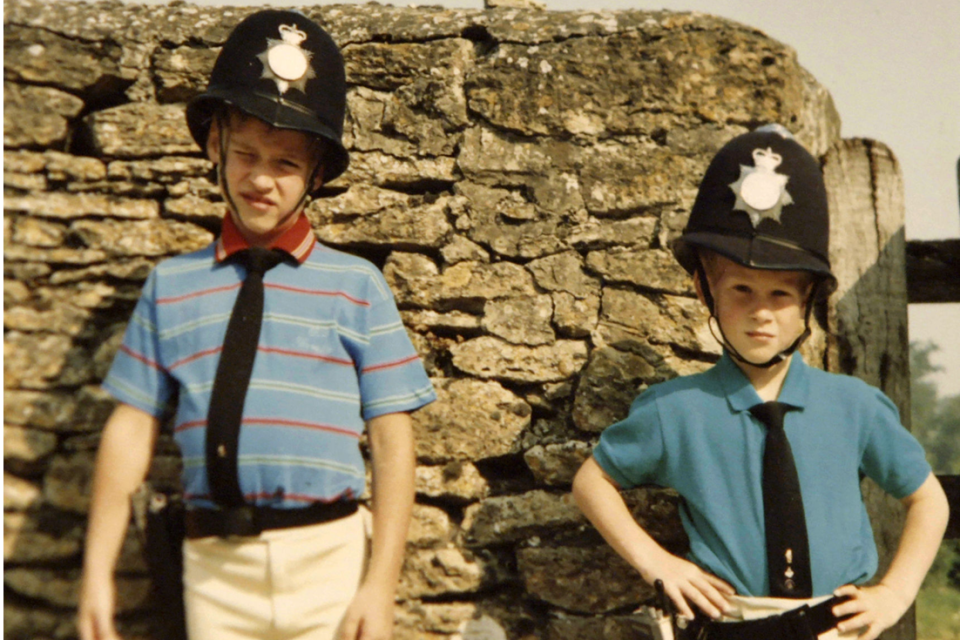 A young Harry and William dress as police officers (Kensington Palace)