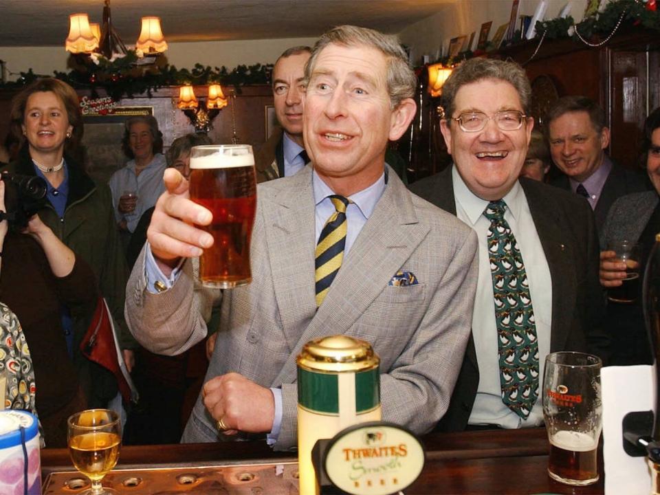 Prince Charles, The Prince of Wales raises a glass as he samples a pint of beer during a visit to a Hotel in Stainforth, Yorkshire Monday, Dec. 17, 2001. The Prince was launching a report that half of all British villages no longer have a pub and seven out of ten now have no shops. The loss of the traditional community hub is harming rural economies, according to the report.