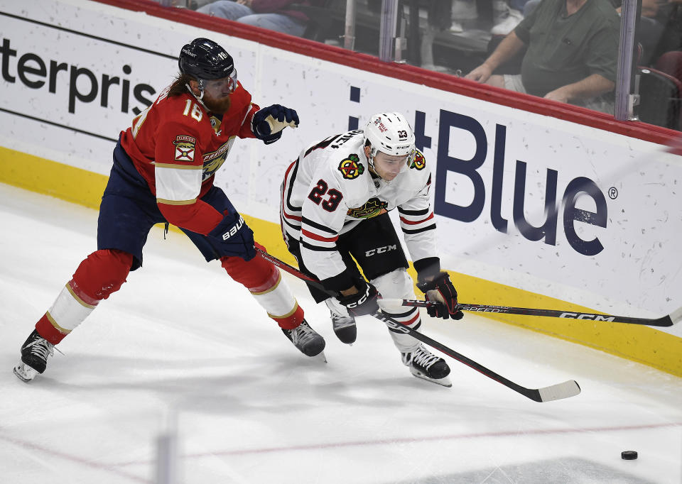 Florida Panthers defenseman Marc Staal (18) tries to stop Chicago Blackhawks center Philipp Kurashev (23) during the first period of an NHL hockey game, Friday, March 10, 2023, in Sunrise, Fla. (AP Photo/Michael Laughlin)