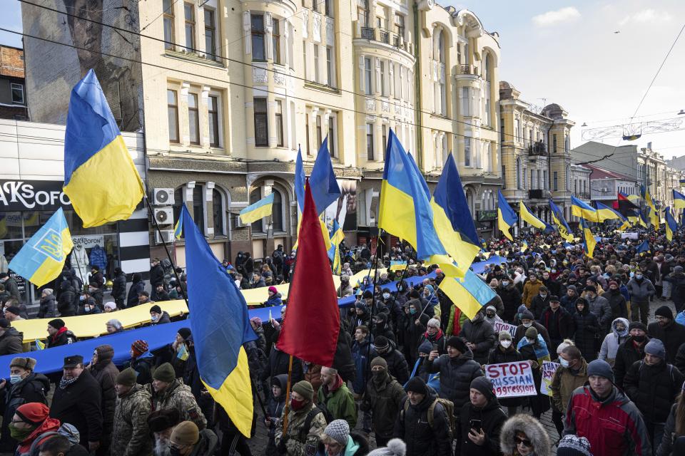 Demonstrators with Ukrainian national flags rally against Russian aggression in the center of Kharkiv, Ukraine's second-largest city, Saturday, Feb. 5, 2022, just 40 kilometers (25 miles) from some of the tens of thousands of Russian troops massed at the border of Ukraine. After weeks of talks in various diplomatic formats have led to no major concessions by Russia and the U.S., it's unclear how much impact the trips will have. But Ukraine's Foreign Minister Dmytro Kuleba said Friday that "top-level visits seriously reduce challenges in the sphere of security and upset the Kremlin's plans." (AP Photo/Evgeniy Maloletka)