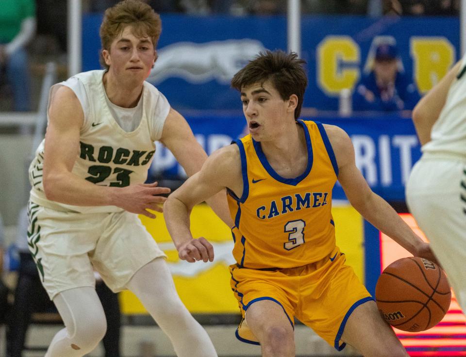 Alex Couto of Carmel High School works a possession against Westfield High School's guard Sam Bishop (23) at Carmel High School, Tuesday, Feb. 28, 2023, during the Westfield boys’ sectional win over Carmel, 43-40. 