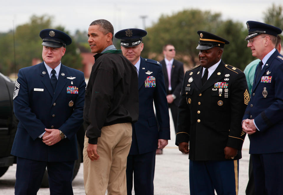 President Barack Obama is greeted by a military personnel as he arrives at at Offutt Air Force Base in Omaha, Nebraska, on August 13, 2012.