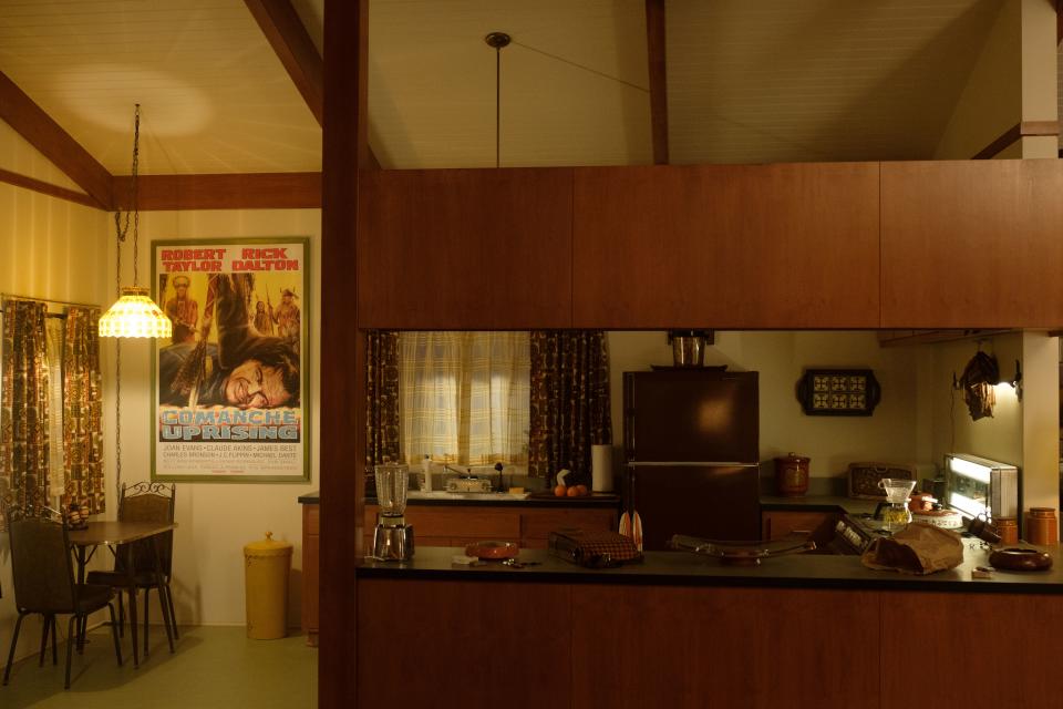 Though movie memorabilia was curated from director Quentin Tarantino’s vast collection, the prop department made a fictitious poster from a Rick Dalton film for this classic ’60s kitchen.