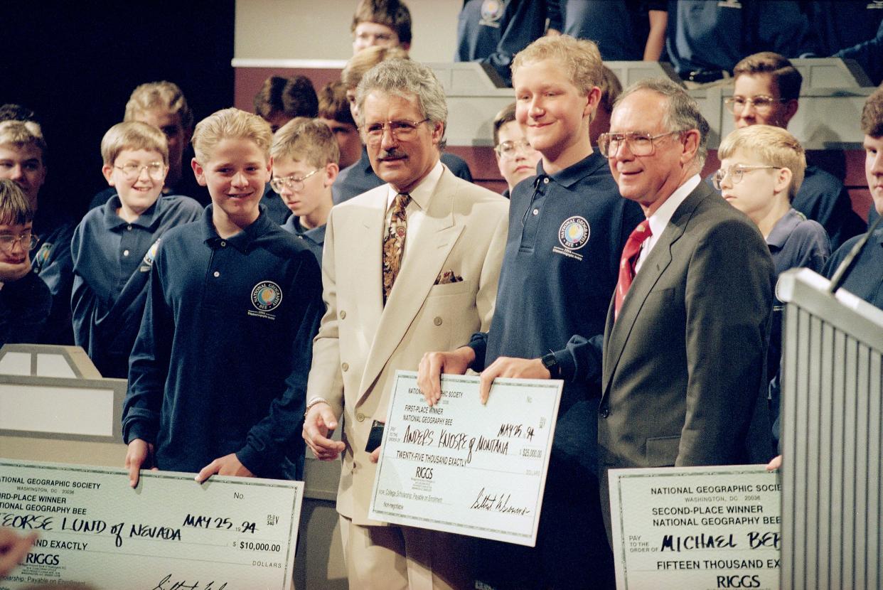 Anders Knospe, 14, of Bozeman, Mont., center, poses with Geography Bee moderator Alex Trebek, left, and National Geographic president and chairman Gilbert Grosvenor after winning the sixth annual National Geography Bee, May 25, 1994, in Washington, D.C.