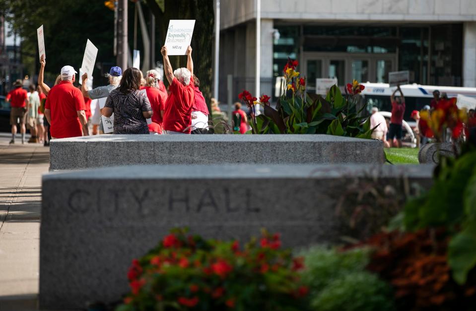 Residents protest a plan to build 8,250 square feet of retail space and 262 apartment units at site of a former Giant Eagle grocery, in Schumacker Place, close to German Village, during a city council meeting, Monday, July 26, 2021.