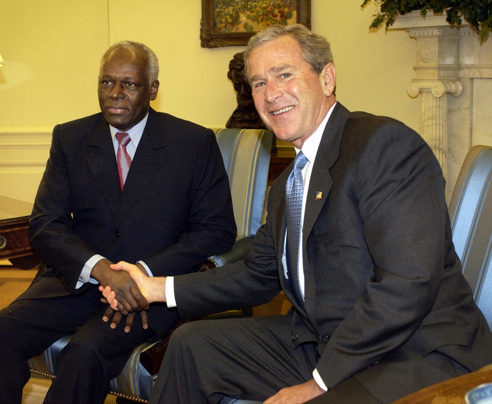 CAPTION CORRECTS AGE - FILE - Angolan President Jose Eduardo dos Santos, left, meets with President George W. Bush in the Oval Office of the White House, Wednesday, May 12, 2004. Former Angolan president Jose Eduardo dos Santos has died in a clinic in Barcelona, Spain after an illness, the Angolan government said. He was 79 years old and died following a long illness, the government said Friday, July 8, 2022 in an announcement on its Facebook page. (AP Photo/Gerald Herbert, File)