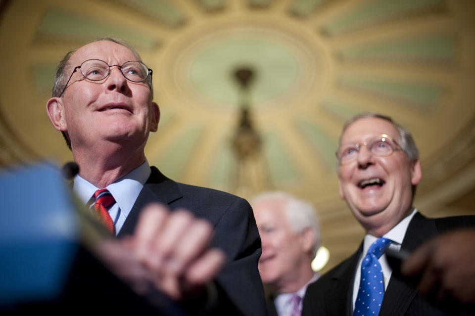 Sen. Lamar Alexander (R-Tenn.) jokes with reporters as McConnell,  laughs in the Ohio Clock Corridor following the Senate Republicans' policy lunch in June 21, 2011. (Photo By Bill Clark/Roll Call)