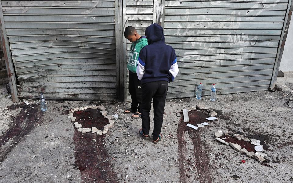 Bloodstains on the ground where Palestinians were killed are marked by circles of stones, in the aftermath of an Israeli raid in the Nur Shams camp for Palestinian refugees