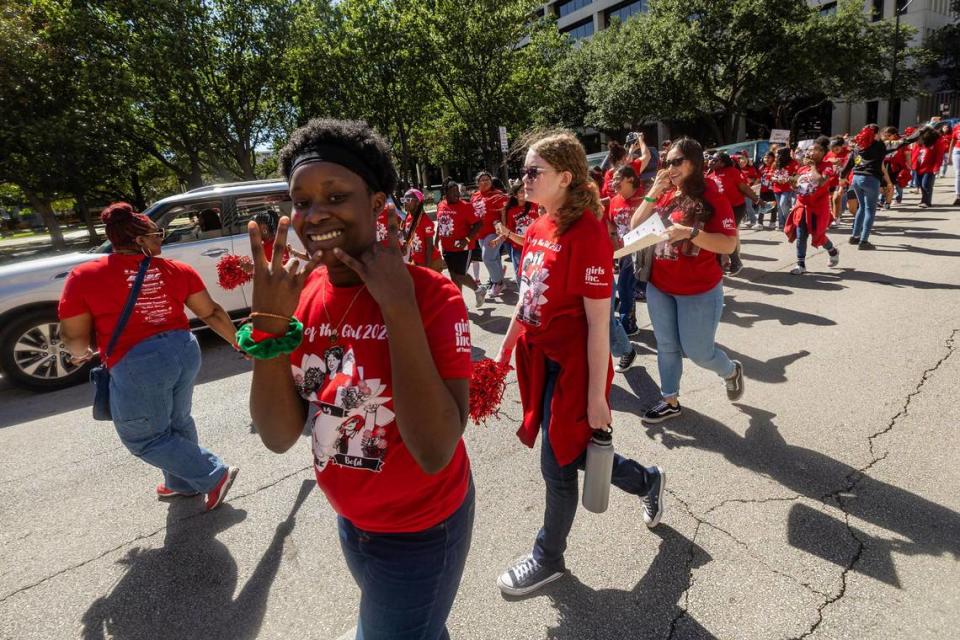 Thousands of women and members of the Girls Inc. of Tarrant County march down Cherry Street for the 2023 Day of the Girl march at Burnett Park in Fort Worth.