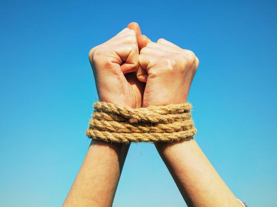 hands tied rope shutterstock_184507361