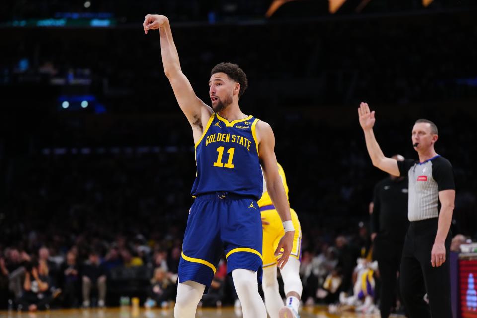 Warriors guard Klay Thompson (11) follows through on a 3-point shot against the Lakers during the second half of their game at Crypto.com Arena in Los Angeles on April 9, 2024.