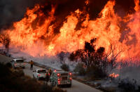 <p>Fire fighters attack the Thomas Fire’s north flank with backfires as they continue to fight a massive wildfire north of Los Angeles, near Ojai , Calif., Dec. 9, 2017. (Photo: Gene Blevins/Reuters) </p>