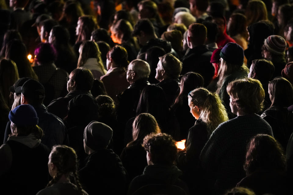 People gather at a vigil for the victims of Wednesday's mass shootings, Sunday, Oct. 29, 2023, outside the Basilica of Saints Peter and Paul in Lewiston, Maine. (AP Photo/Matt Rourke)