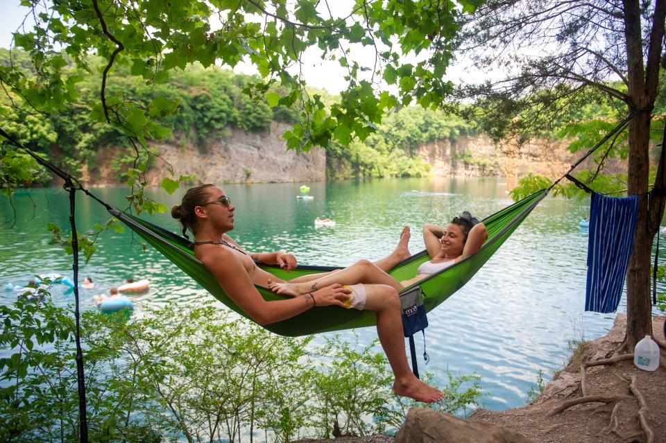 Zane Kidd and Kimmy Ingle hang in a hammock at Augusta Quarry in Fort Dickerson Park on June 15, 2022. While the quarry will be closed for renovations, with construction expected to wrap by summer 2024, the park remains open for picnics and hiking along 3.5 miles of trails in South Knoxville.