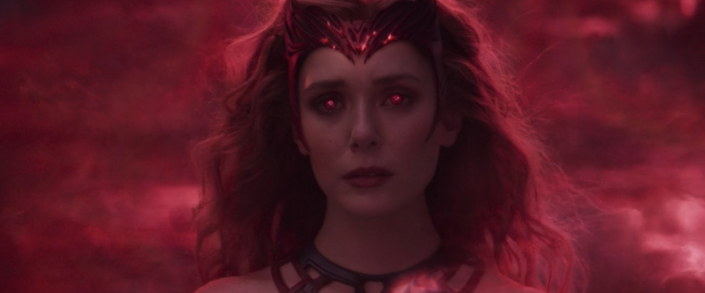 A close up of Wanda transforming into Scarlet Witch