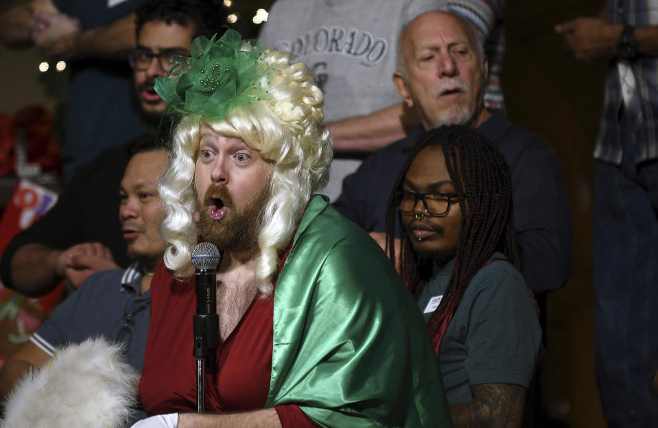 Joey Young, assistant artistic director of the Out Loud Colorado Springs Men's Chorus, performs during a Christmas show rehearsal in Colorado Springs, Colo., on Wednesday, Nov. 30, 2022. The group has taken an active role in the healing process after a Nov. 19 attack killed five people at an LGBTQ nightclub in Colorado Springs. (AP Photo/Thomas Peipert)