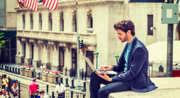 Man at Wall Street on laptop.