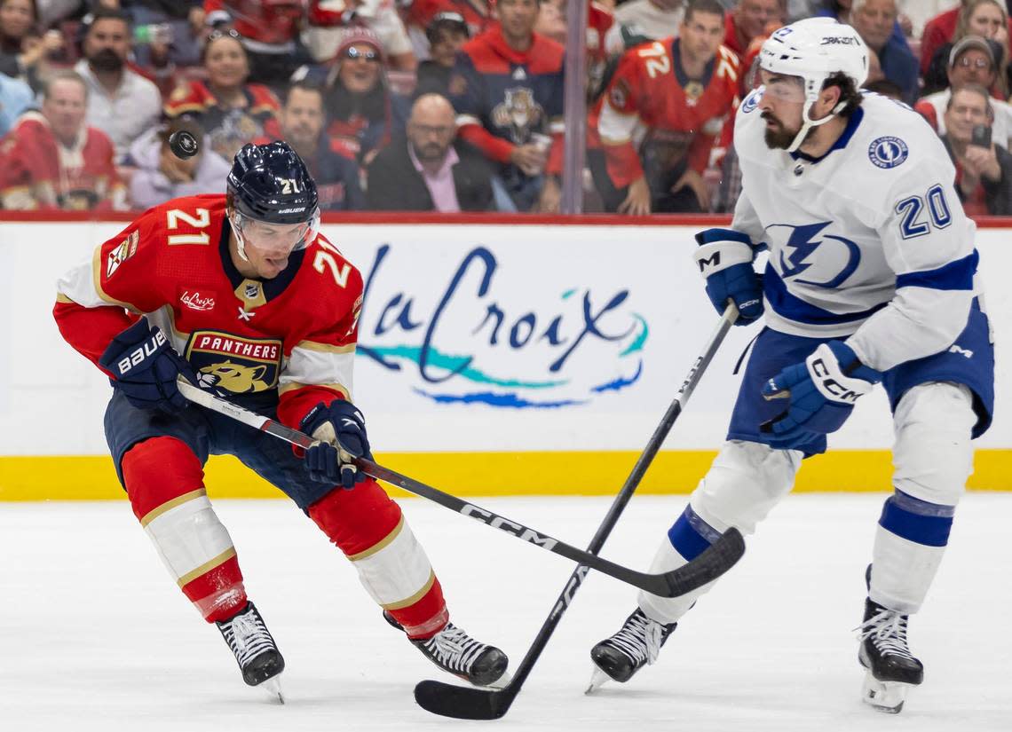 Florida Panthers center Nick Cousins (21) and Tampa Bay Lightning left wing Nicholas Paul (20) compete for the puck in the second period in Game 2 of the first-round of the 2024 Stanley Cup Playoffs at Amerant Bank Arena on Tuesday, April 23, 2024, in Sunrise, Fla.