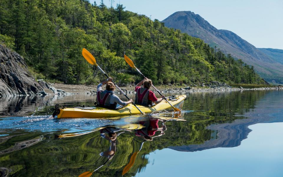 Kayaking in Gros Morne National Park; Trout River, Newfoundland, Canada