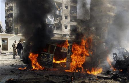 Burning buses are seen at a bus station hit by what activists said was an airstrike by forces loyal to Syria's President Bashar al-Assad in Jisr al-Hajj in Aleppo January 21, 2014. REUTERS/Ammar Abdullah