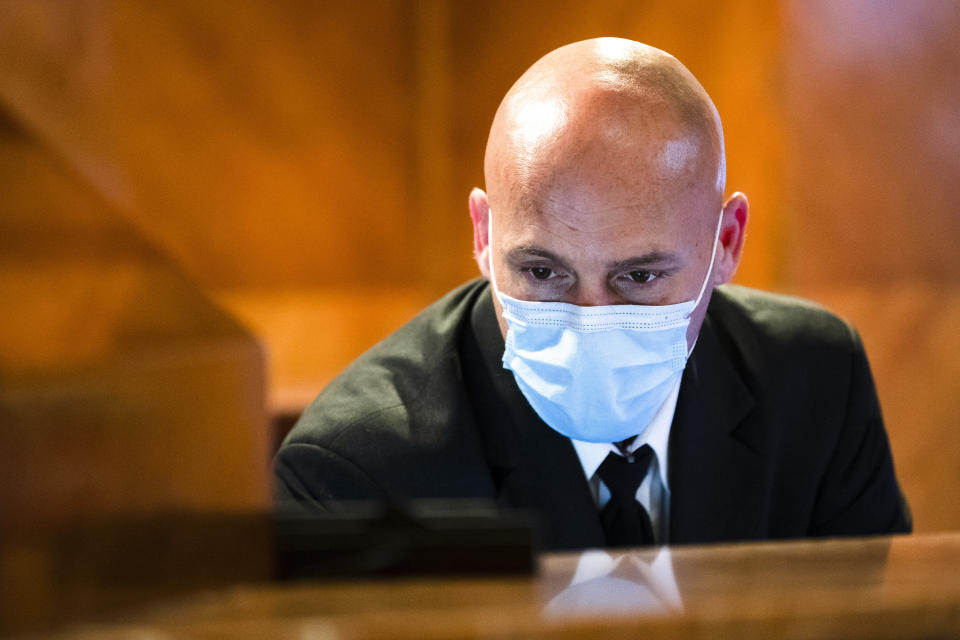 Concierge Joe DeLuca, poses for a photograph at the front desk of an apartment building in New York, April 6, 2020. While tens of thousands of New Yorkers work at home during the COVID-19 pandemic, people like DeLuca keep the city running amid the lockdown. (AP Photo/Matt Rourke)