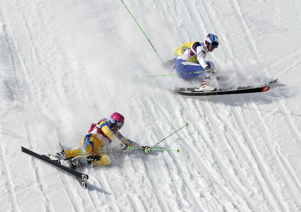 Sweden's Victor Oehling Norberg, left, and Russia's Igor Korotkov crash during a men's ski cross heat at the Rosa Khutor Extreme Park, at the 2014 Winter Olympics, Thursday, Feb. 20, 2014, in Krasnaya Polyana, Russia. (AP Photo/Andy Wong)