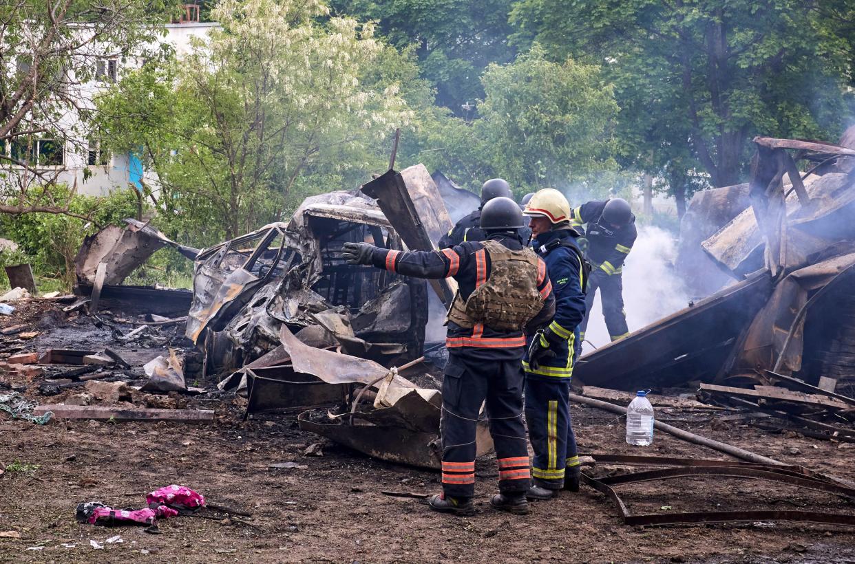 Ukrainian rescuers work at the site of a shelling of a residential area in Kharkiv, Ukraine (EPA)