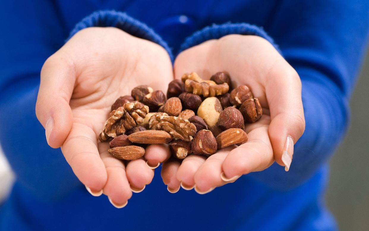 Eating a few nuts each day could help to ward off middle-aged spread
