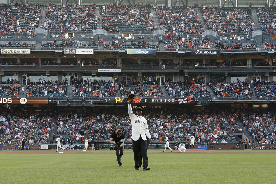 Former San Francisco Giants player Barry Bonds waves as he takes left field after a ceremony to retire his jersey number before a baseball game between the Giants and the Pittsburgh Pirates in San Francisco, Saturday, Aug. 11, 2018. (Lachlan Cunningham/Pool Photo via AP)