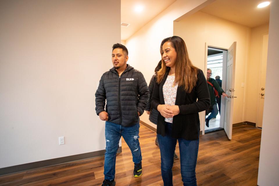 Margarita Vasquez Cruz, right, and Heron Maya Ruiz walk through their new home built by students in Eugene School District 4J’s Future Build career technical education program.