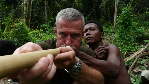 Hayden Turner tries his hand at a blowgun with the Malaysian Jahai tribe. (Photo courtesy of NGCI)
