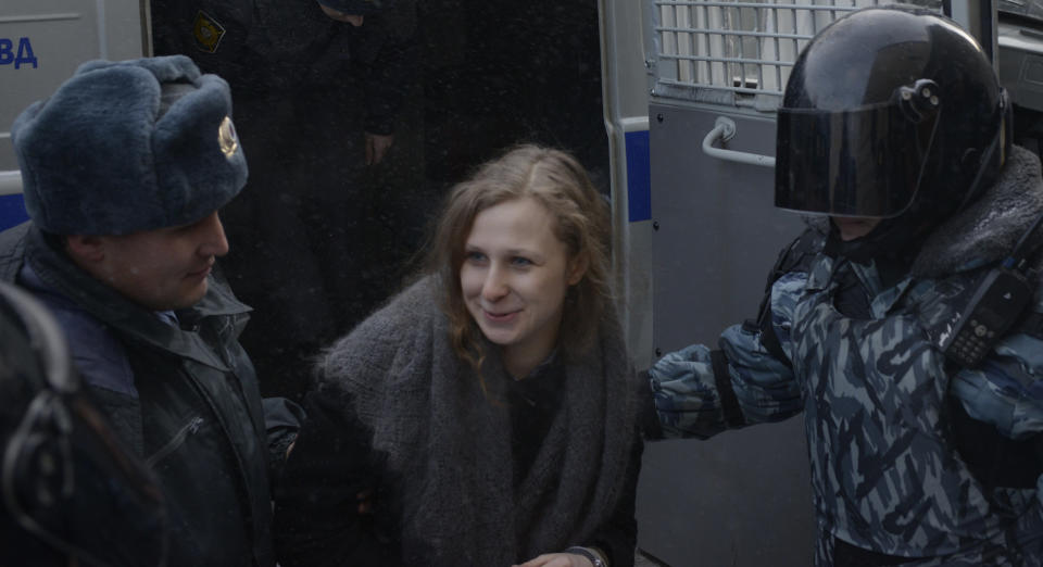 Jailed feminist punk band Pussy Riot member Maria Alekhina, center, is escorted to a court room in the town of Berezniki, some 1500 km (940 miles) north-east of Moscow, Russia, on Wednesday, Jan. 16, 2013. (AP Photo/Alexander Agafonov)