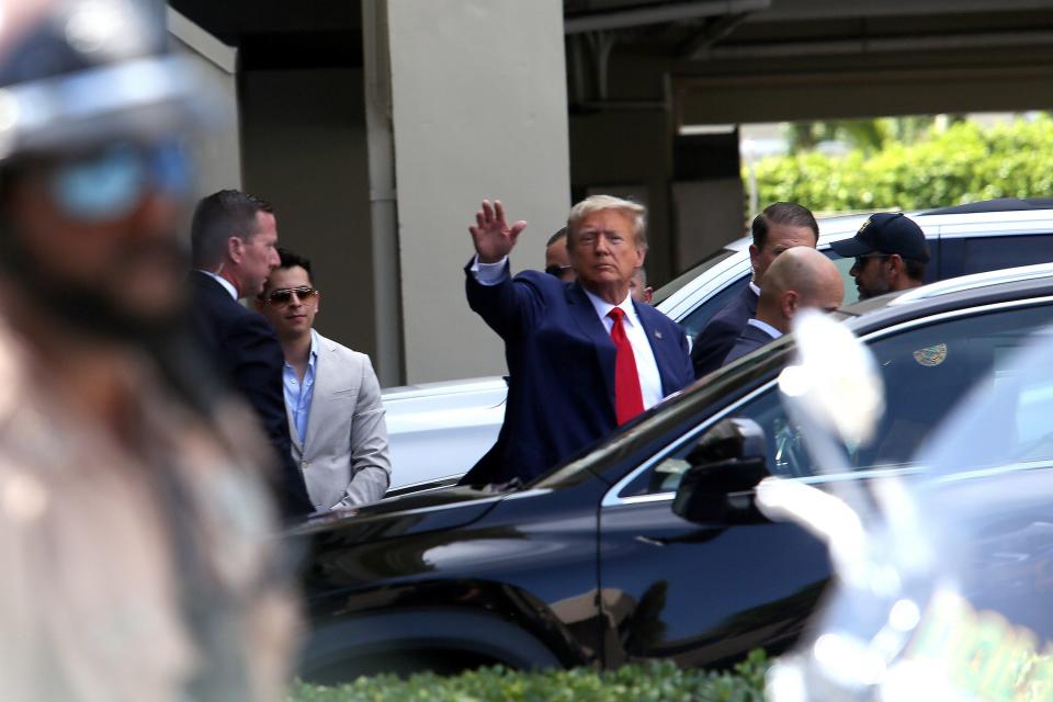 Former U.S. President Donald Trump waves as he makes a visit to the Cuban restaurant Versailles after he appeared for his arraignment on June 13, 2023 in Miami, Florida. Trump pleaded not guilty to 37 federal charges including possession of national security documents after leaving office, obstruction, and making false statements. 