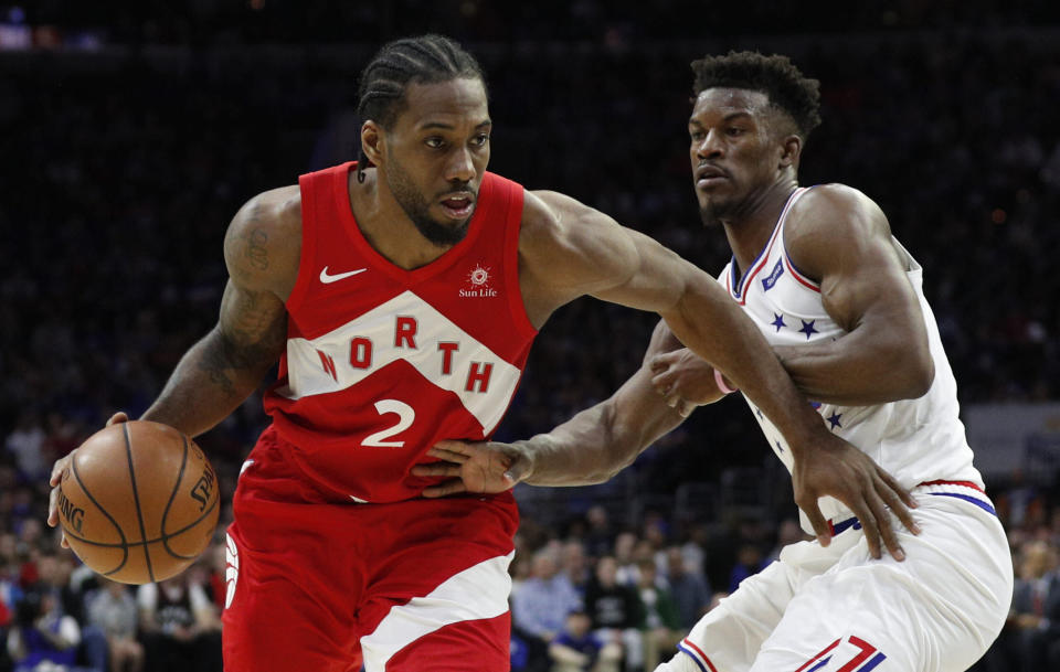 Toronto Raptors' Kawhi Leonard, left, drives against Philadelphia 76ers' Jimmy Butler, right, during the second half of Game 4 of a second-round NBA basketball playoff series, Sunday, May 5, 2019, in Philadelphia. The Raptors won 101-96. (AP Photo/Chris Szagola)