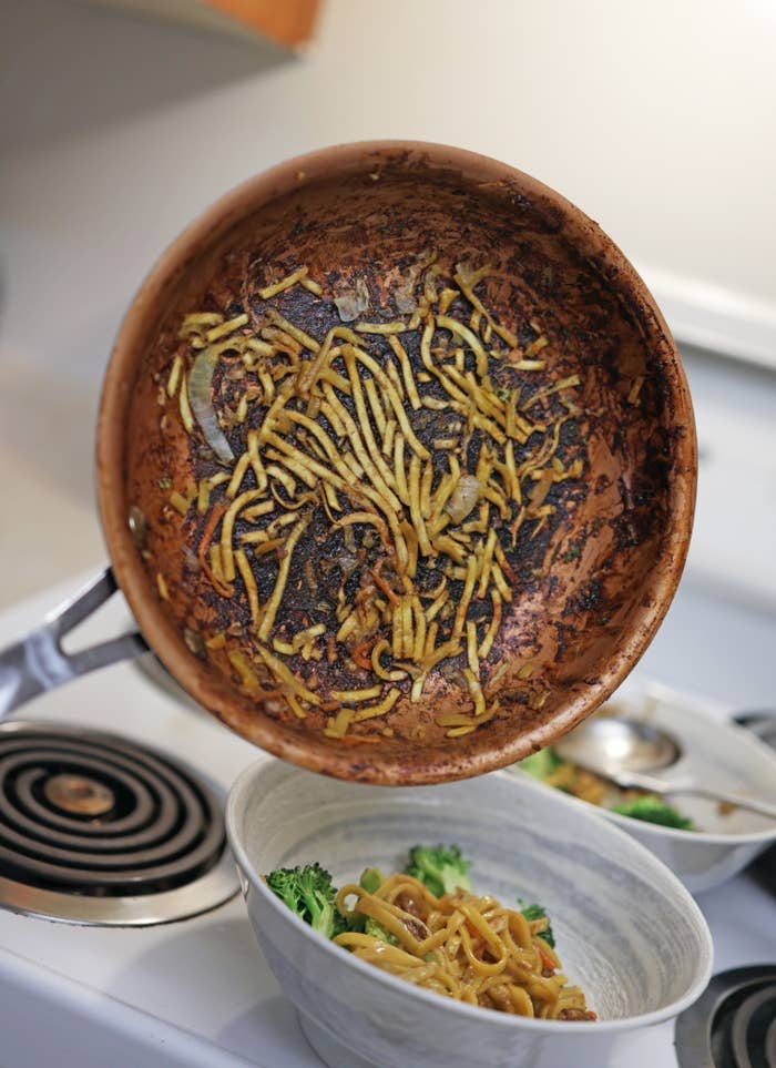 Burnt, brown soy sauce noodles stuck to a skillet