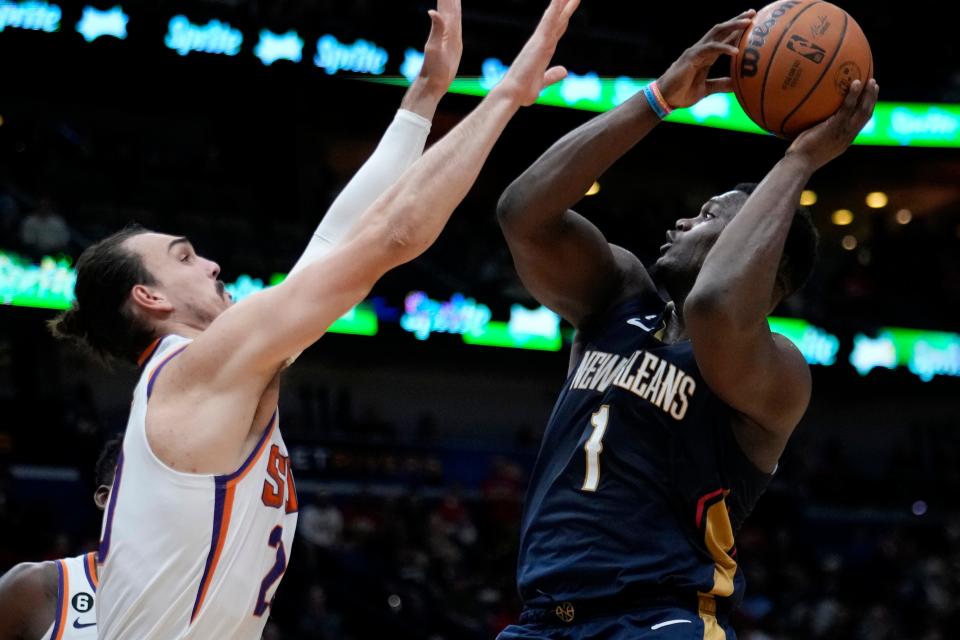 New Orleans Pelicans forward Zion Williamson (1) shoots against Phoenix Suns forward Dario Saric in the second half of an NBA basketball game in New Orleans, Sunday, Dec. 11, 2022. The Pelicans won 129-124. (AP Photo/Gerald Herbert)