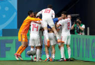 Soccer Football - World Cup - Group B - Morocco vs Iran - Saint Petersburg Stadium, Saint Petersburg, Russia - June 15, 2018 Iran players celebrate after Morocco's Aziz Bouhaddouz scores an own goal and the first for Iran REUTERS/Henry Romero