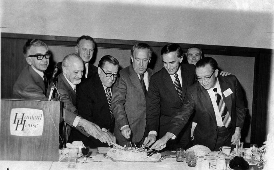 From left, Bob Philip, Sam Volpentest, Clif Lahue, Sen. Warren G. Magnuson, Sen. Henry Jackson, Gov. Dan Evans, former Herald publisher Glenn C. Lee (in rear) and Jim Ramey, Atomic Energy Commissioner are shown in this file photo from the 1970s cutting a cake for the Tri­City Nuclear Industrial Council.