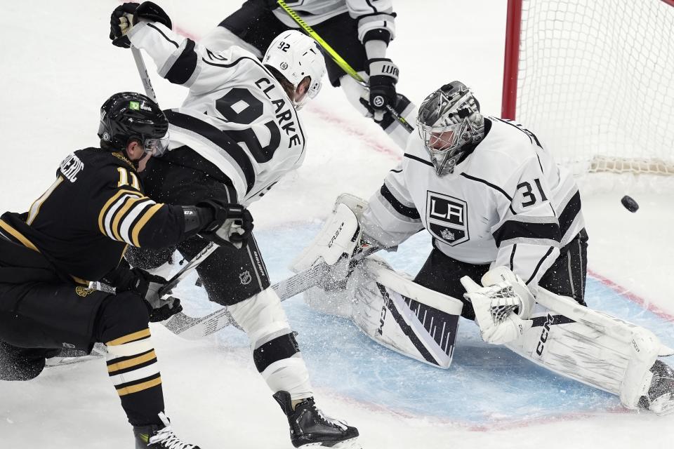 Boston Bruins' Trent Frederic (11) scores on Los Angeles Kings' David Rittich (31) during the third period of an NHL hockey game, Saturday, Feb. 17, 2024, in Boston. (AP Photo/Michael Dwyer)