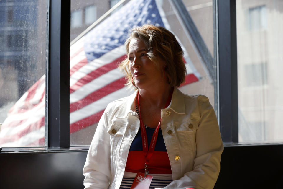 Angela Dahms, a Washtenaw County alternate delegate, waits outside the meeting room during a break in voting at the Michigan GOP convention, Saturday, March 2, 2024, in Grand Rapids, Mich. (AP Photo/Al Goldis)