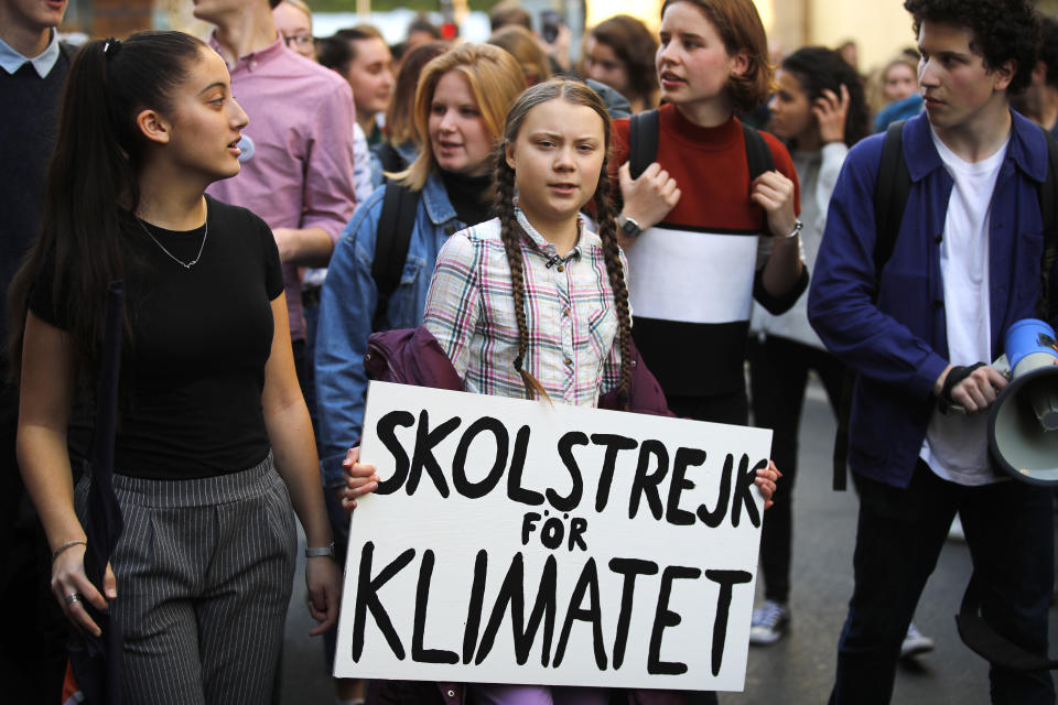 Swedish teenager Greta Thunberg, center, leads a march of thousands of French students through Paris, France, to draw more attention to fighting climate change, Friday, Feb. 22, 2019. Sign reads : "school strike for the climate". (AP Photo/Francois Mori)