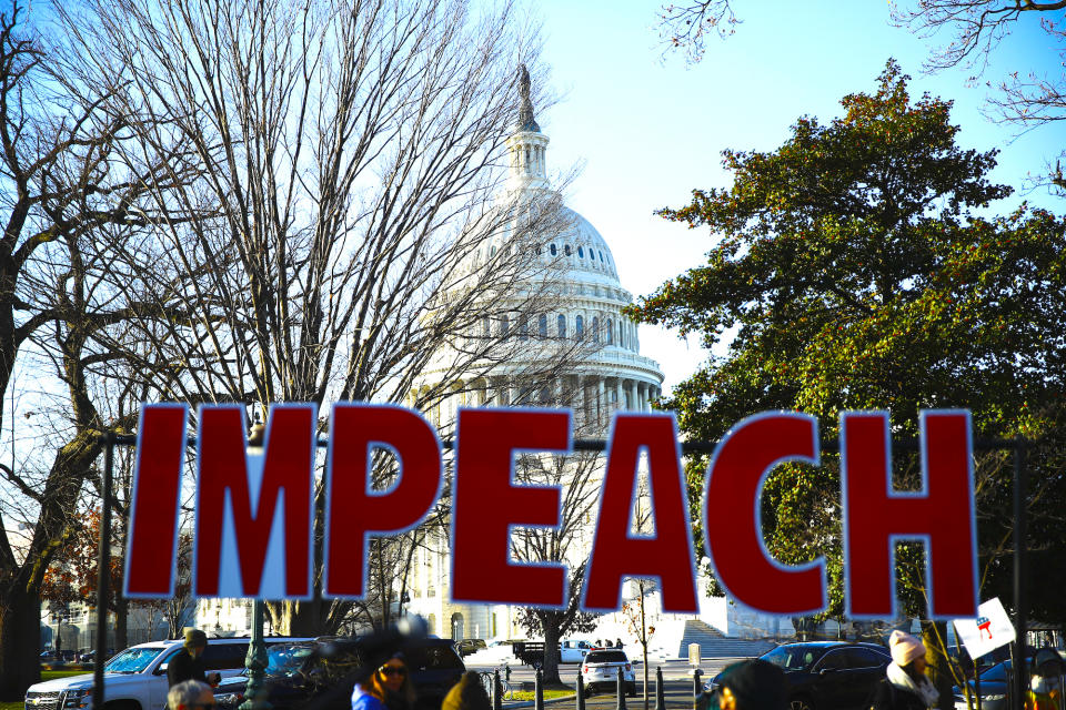 Protesters demonstrate as the House of Representatives begins debate on the articles of impeachment against President Donald Trump at the U.S. Capitol building, Wednesday, Dec. 18, 2019, on Capitol Hill in Washington. (AP Photo/Matt Rourke)