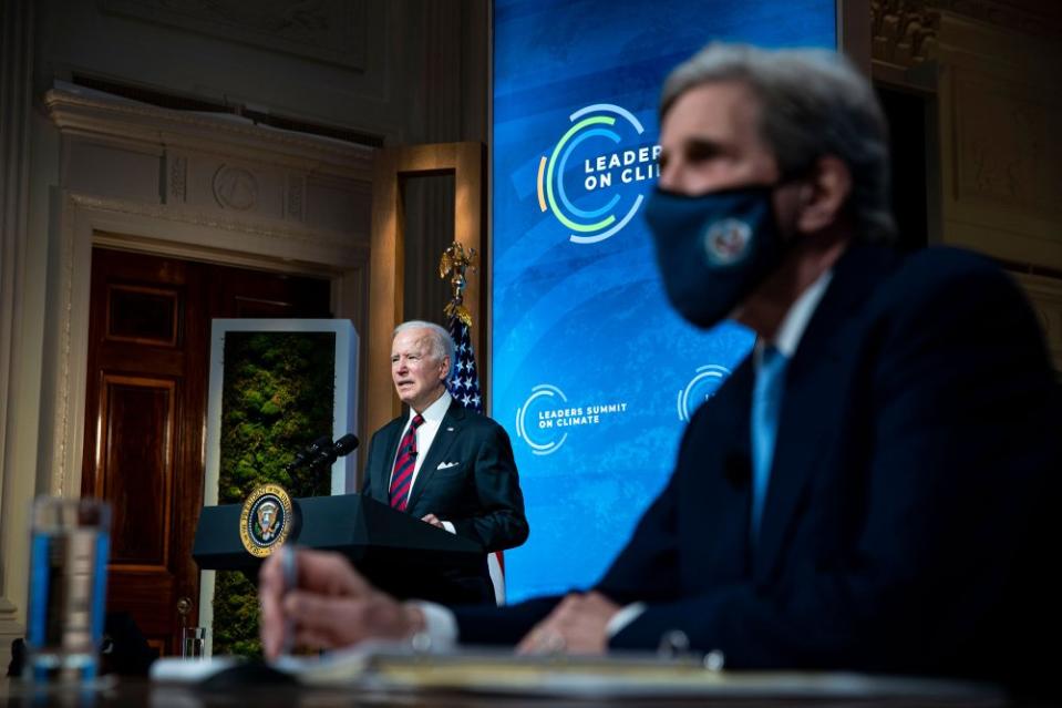 President Joe Biden delivers remarks as John Kerry listens during a virtual Leaders Summit on Climate with 40 world leaders at the White House on April 22, 2021.<span class="copyright">Al Drago—Pool/Getty Images</span>
