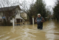 <p>A resident walks in a flooded street of Esbly, east of Paris, where the Grand Morin river floods Thursday, Jan.25, 2018. (Photo: Thibault Camus/AP) </p>