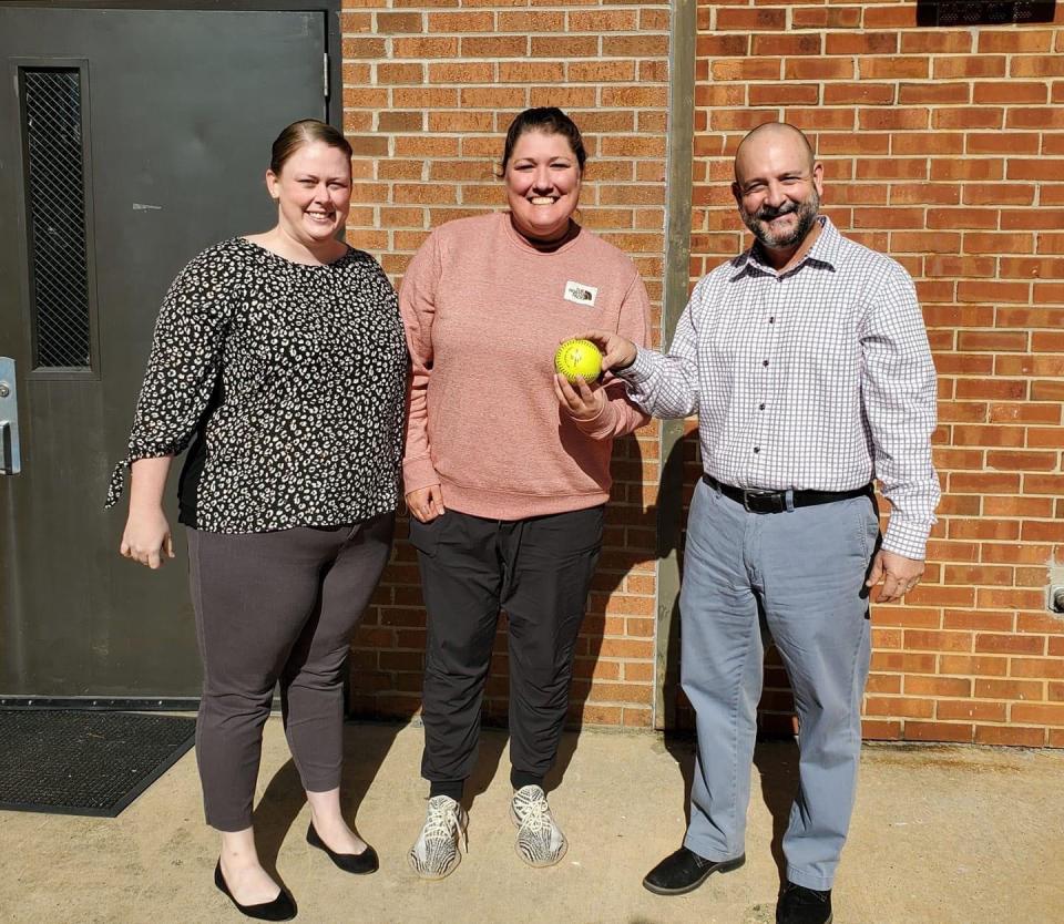 Allison Lyerly (center) is the new varsity softball coach Ledford.  At right is former coach Charlie Brown. Also pictured is new assistant coach Catlyn Moser (left). [Contributed photo]