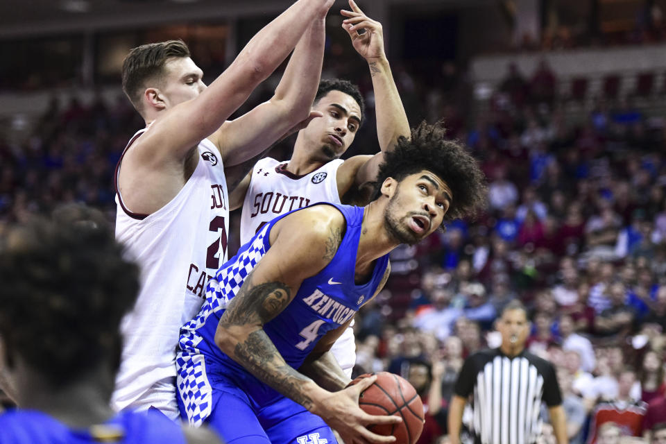 Kentucky forward Nick Richards (4) looks for a shot as South Carolina's Maik Kotsar, left, and Justin Minaya defend during the first half of an NCAA college basketball game Wednesday, Jan. 15, 2020, in Columbia, S.C. (AP Photo/Sean Rayford)