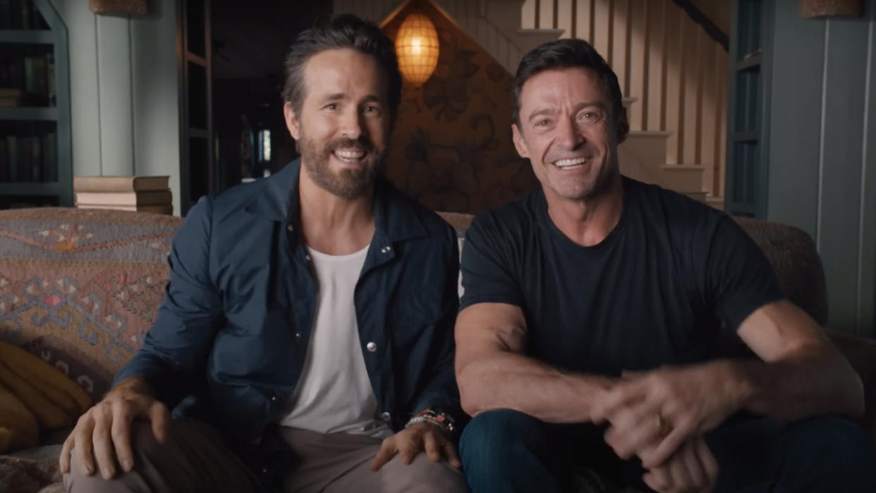  Hugh Jackman and Ryan Reynolds sitting side by side in the Deadpool 3 announcement video. 